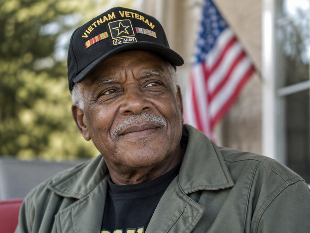 Portrait of an older African American Army veteran wearing a Vietnam Veteran cap